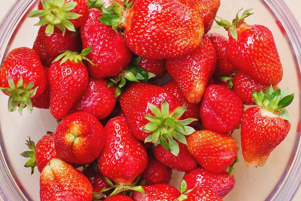 Bowl heaped with ripe red strawberries